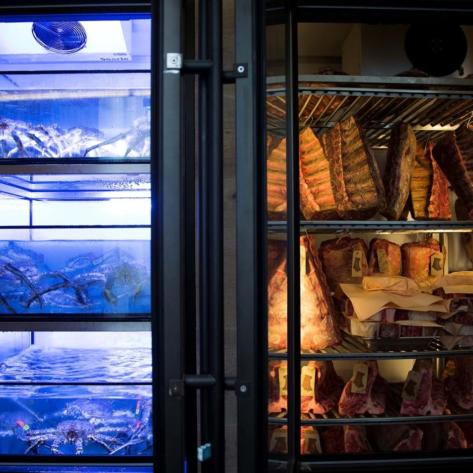 hanging dried meat next to crab tanks