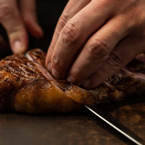 knife cutting through steak