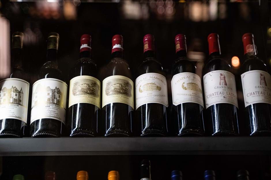 row of red wine bottles